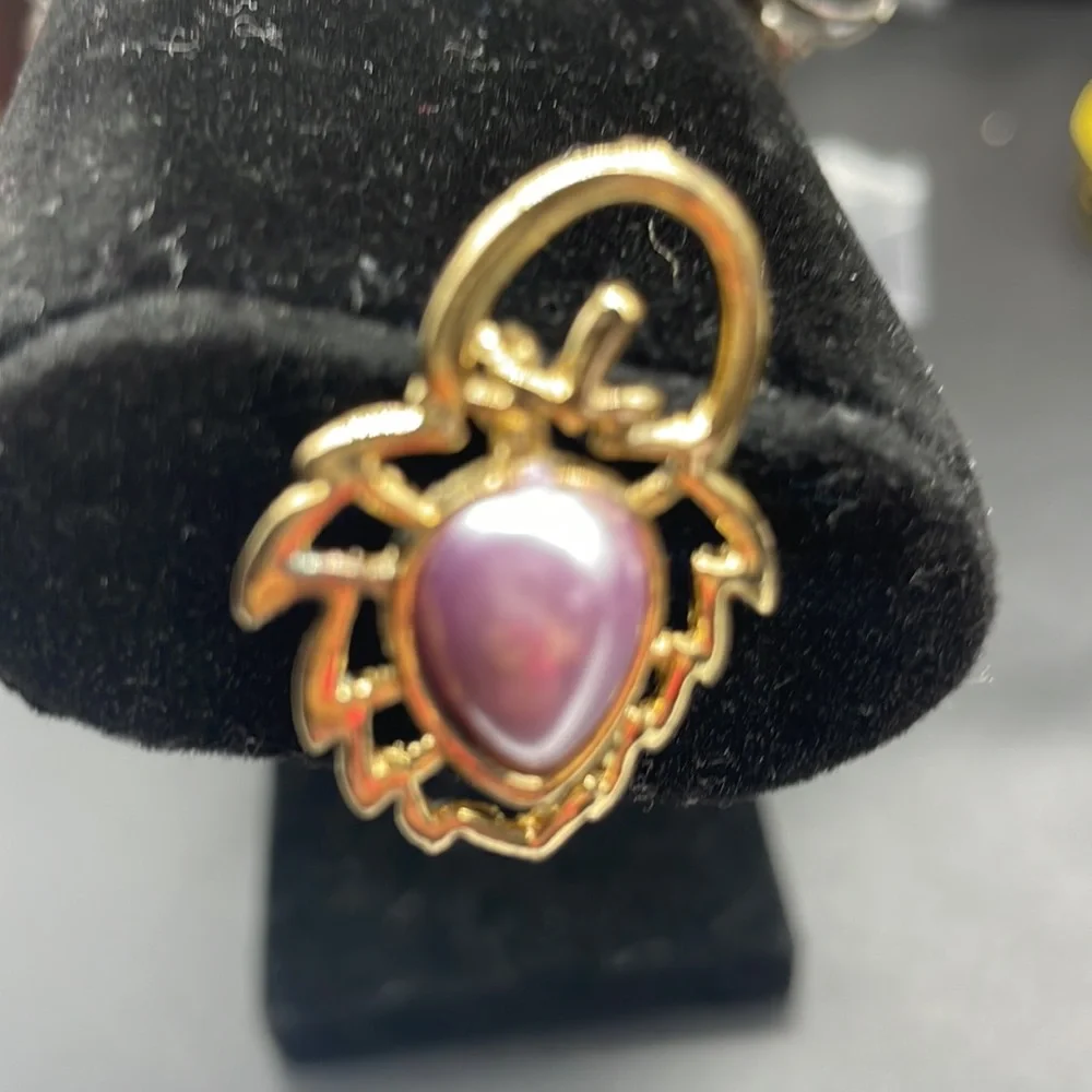 Gold plated brooch with a stone in the center | the stone color is a lavender